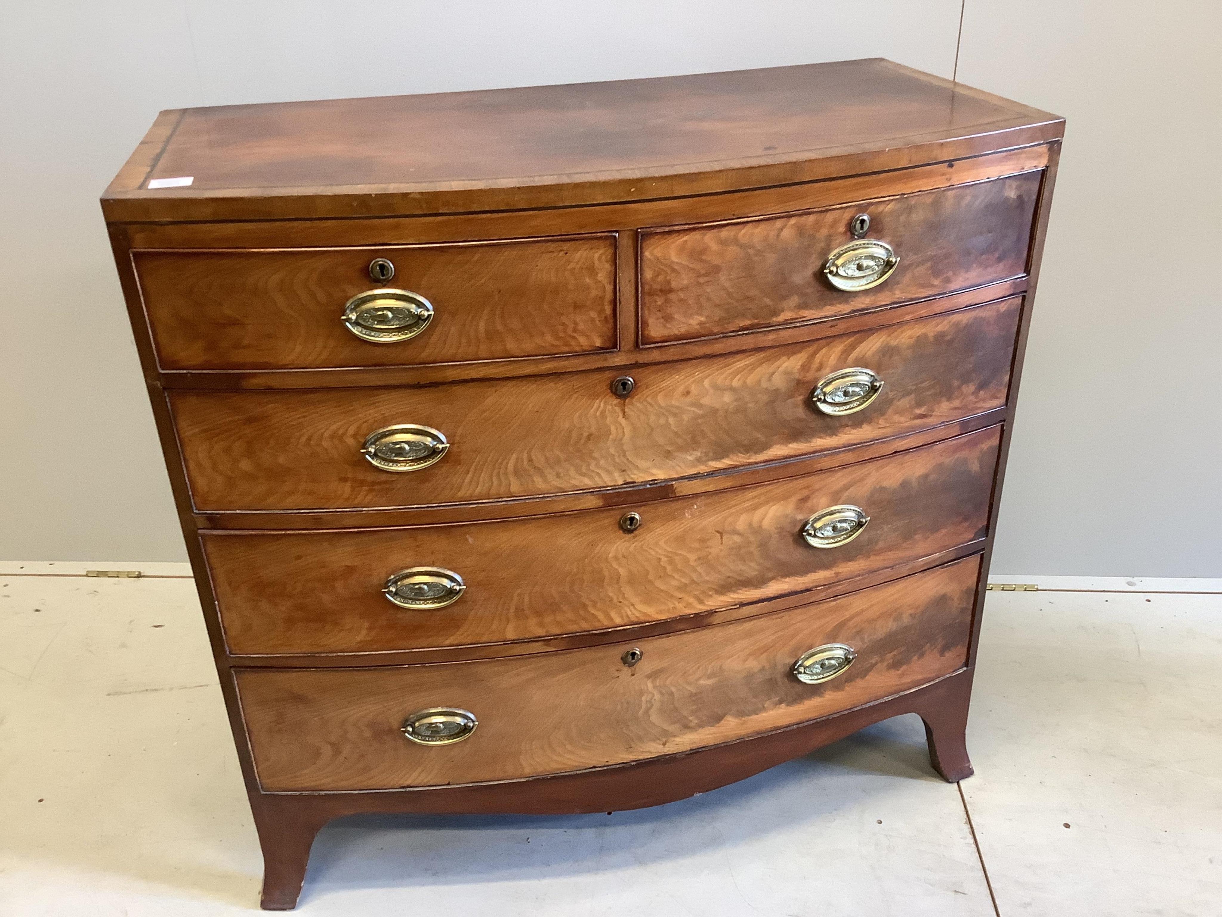 A Regency banded mahogany bowfronted chest, fitted two short and three long drawers, with oval stamped brass handles, width 103cm, depth 54cm, height 97cm. Condition - poor to fair